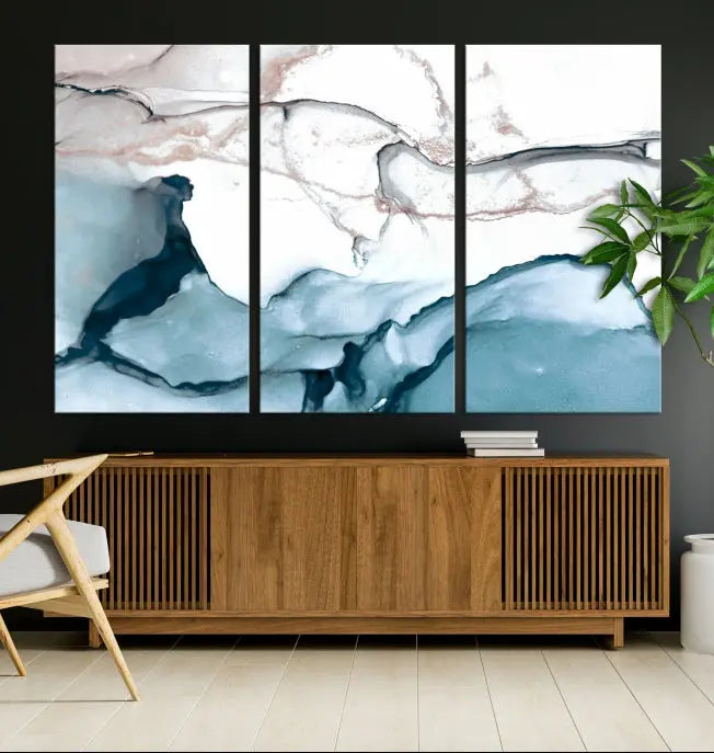 The modern living room features the Blue and Rose Gold Marble Fluid Effect Wall Art Abstract Canvas Art Print displayed on a gray wall.