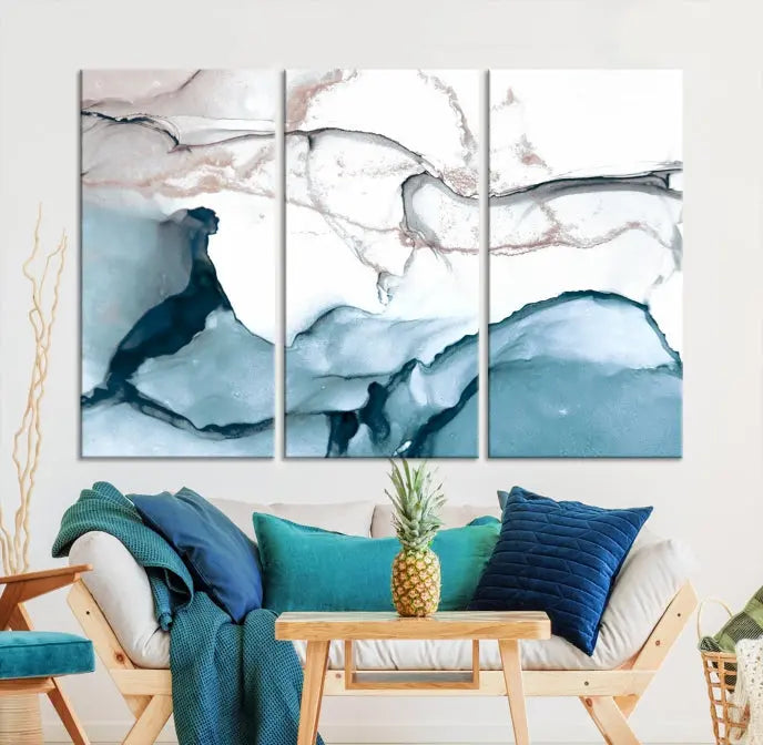 The modern living room features the Blue and Rose Gold Marble Fluid Effect Wall Art Abstract Canvas Art Print displayed on a gray wall.