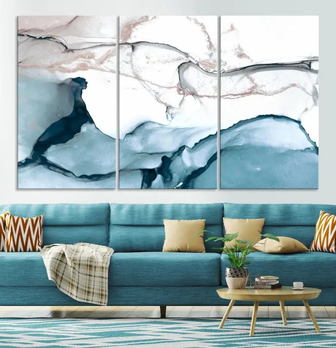 The modern living room features the Blue and Rose Gold Marble Fluid Effect Wall Art Abstract Canvas Art Print displayed on a gray wall.