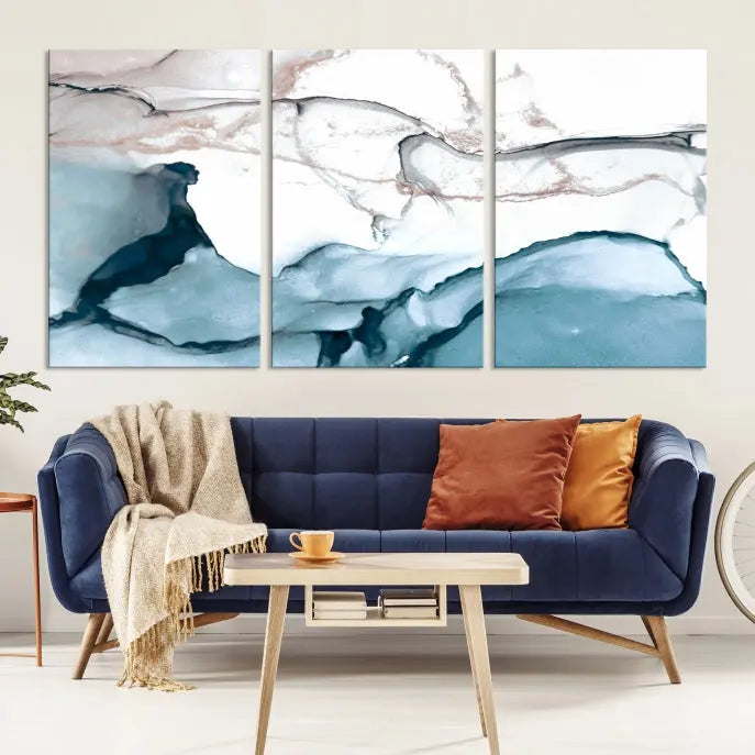 The modern living room features the Blue and Rose Gold Marble Fluid Effect Wall Art Abstract Canvas Art Print displayed on a gray wall.