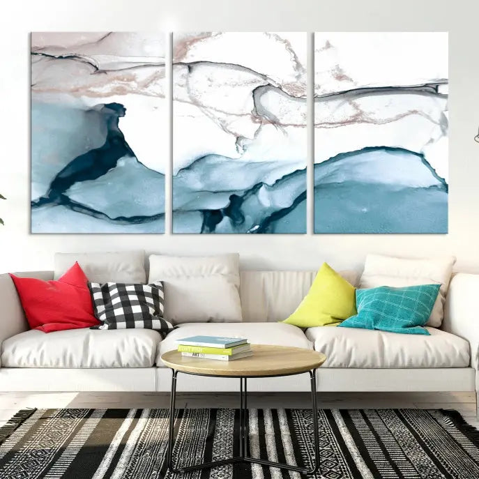 The modern living room features the Blue and Rose Gold Marble Fluid Effect Wall Art Abstract Canvas Art Print displayed on a gray wall.