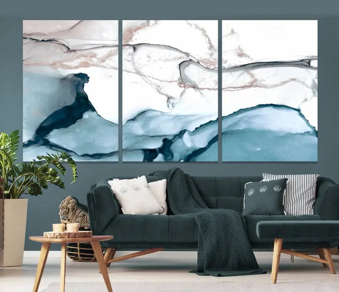 The modern living room features the Blue and Rose Gold Marble Fluid Effect Wall Art Abstract Canvas Art Print displayed on a gray wall.