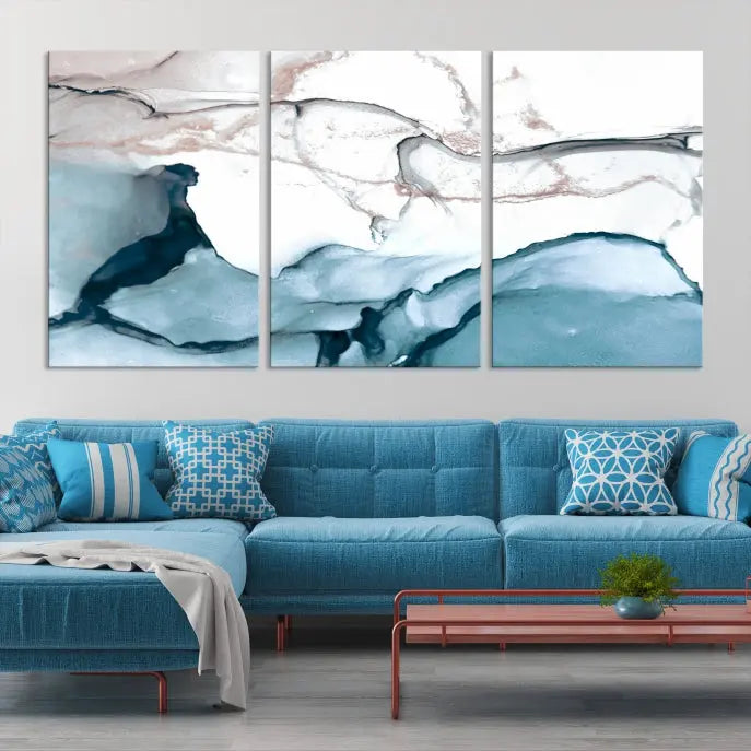 The modern living room features the Blue and Rose Gold Marble Fluid Effect Wall Art Abstract Canvas Art Print displayed on a gray wall.