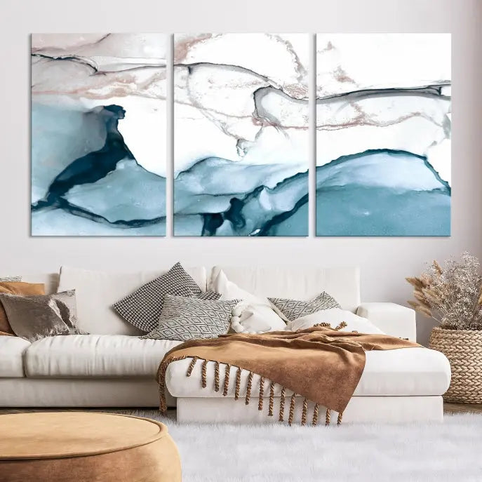 The modern living room features the Blue and Rose Gold Marble Fluid Effect Wall Art Abstract Canvas Art Print displayed on a gray wall.