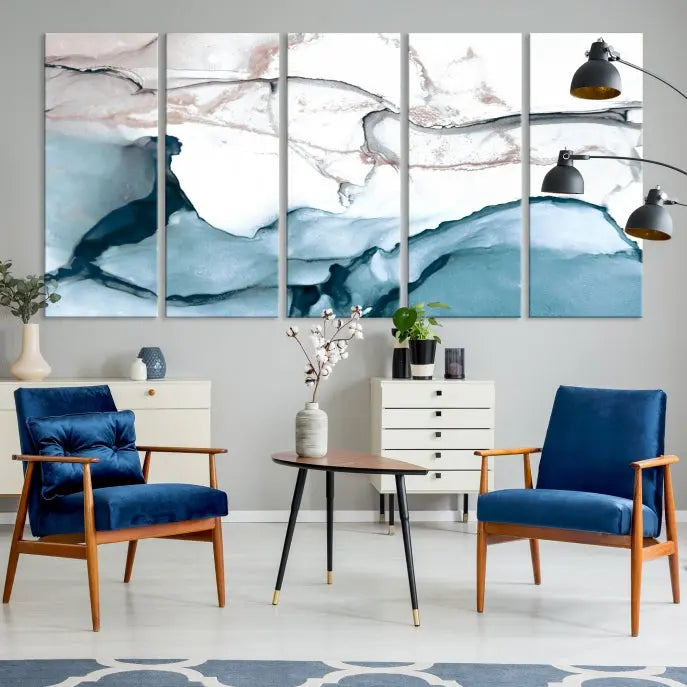 The modern living room features the Blue and Rose Gold Marble Fluid Effect Wall Art Abstract Canvas Art Print displayed on a gray wall.