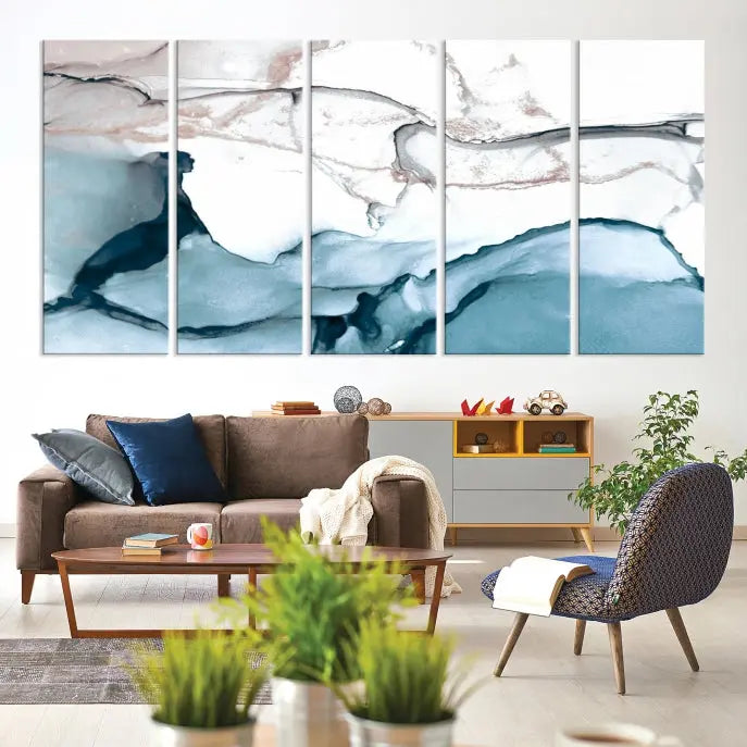 The modern living room features the Blue and Rose Gold Marble Fluid Effect Wall Art Abstract Canvas Art Print displayed on a gray wall.