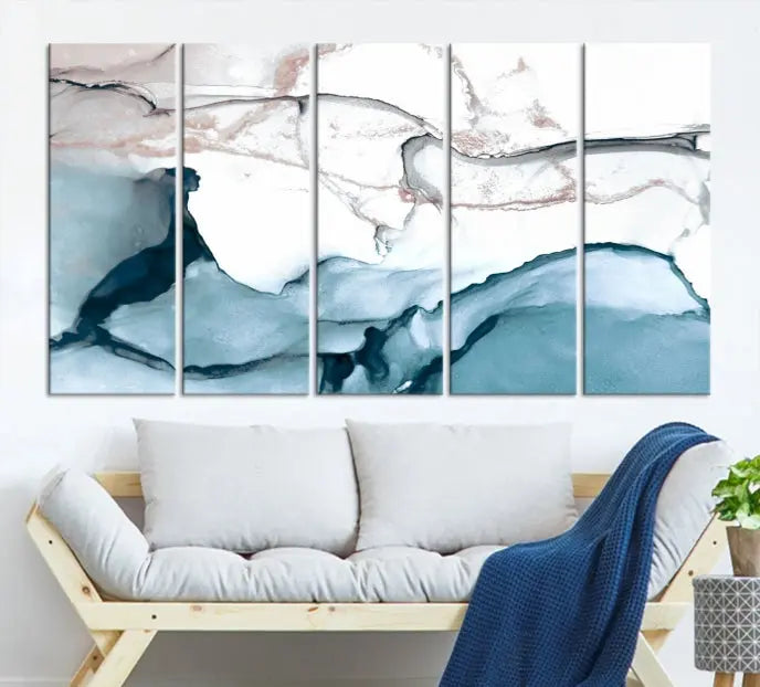 The modern living room features the Blue and Rose Gold Marble Fluid Effect Wall Art Abstract Canvas Art Print displayed on a gray wall.