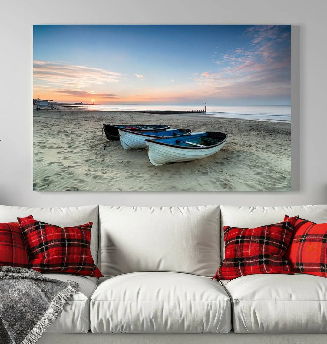 The "Boats On The Beach Wall Art Canvas Print," featuring a triptych photo of boats at sunset, is printed on museum-quality canvas with a UV-protective coating.