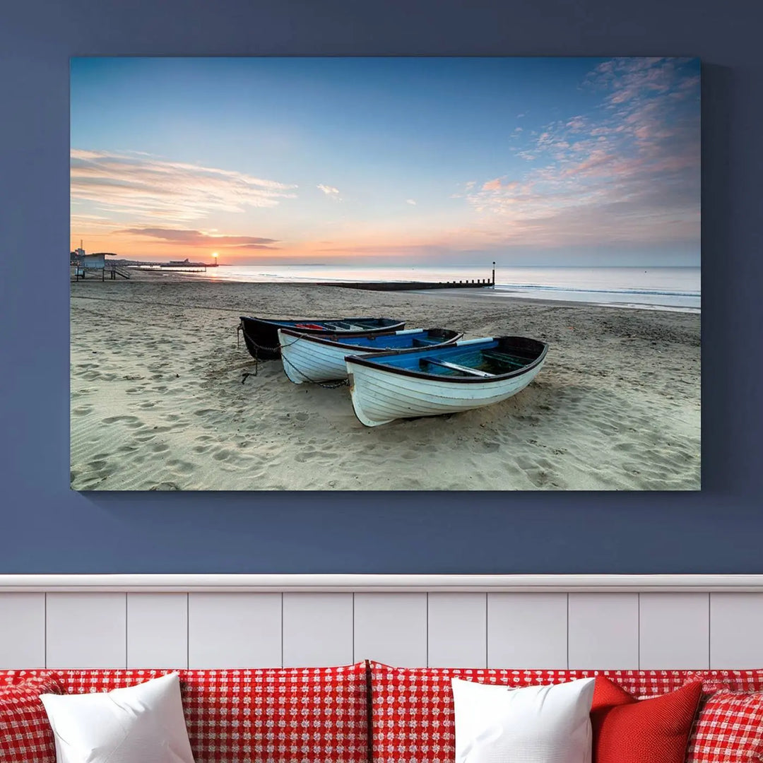 The "Boats On The Beach Wall Art Canvas Print," featuring a triptych photo of boats at sunset, is printed on museum-quality canvas with a UV-protective coating.