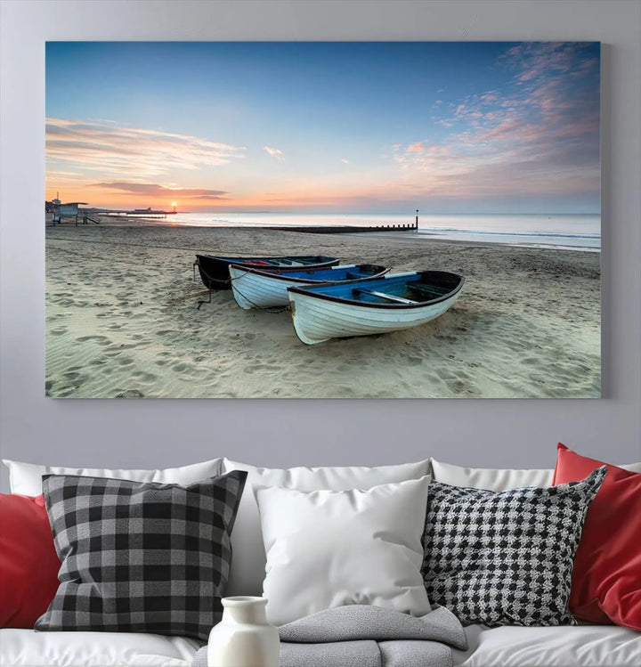 The "Boats On The Beach Wall Art Canvas Print," featuring a triptych photo of boats at sunset, is printed on museum-quality canvas with a UV-protective coating.