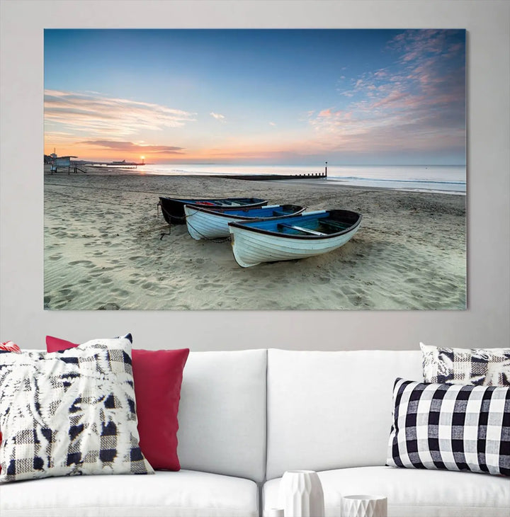 The "Boats On The Beach Wall Art Canvas Print," featuring a triptych photo of boats at sunset, is printed on museum-quality canvas with a UV-protective coating.