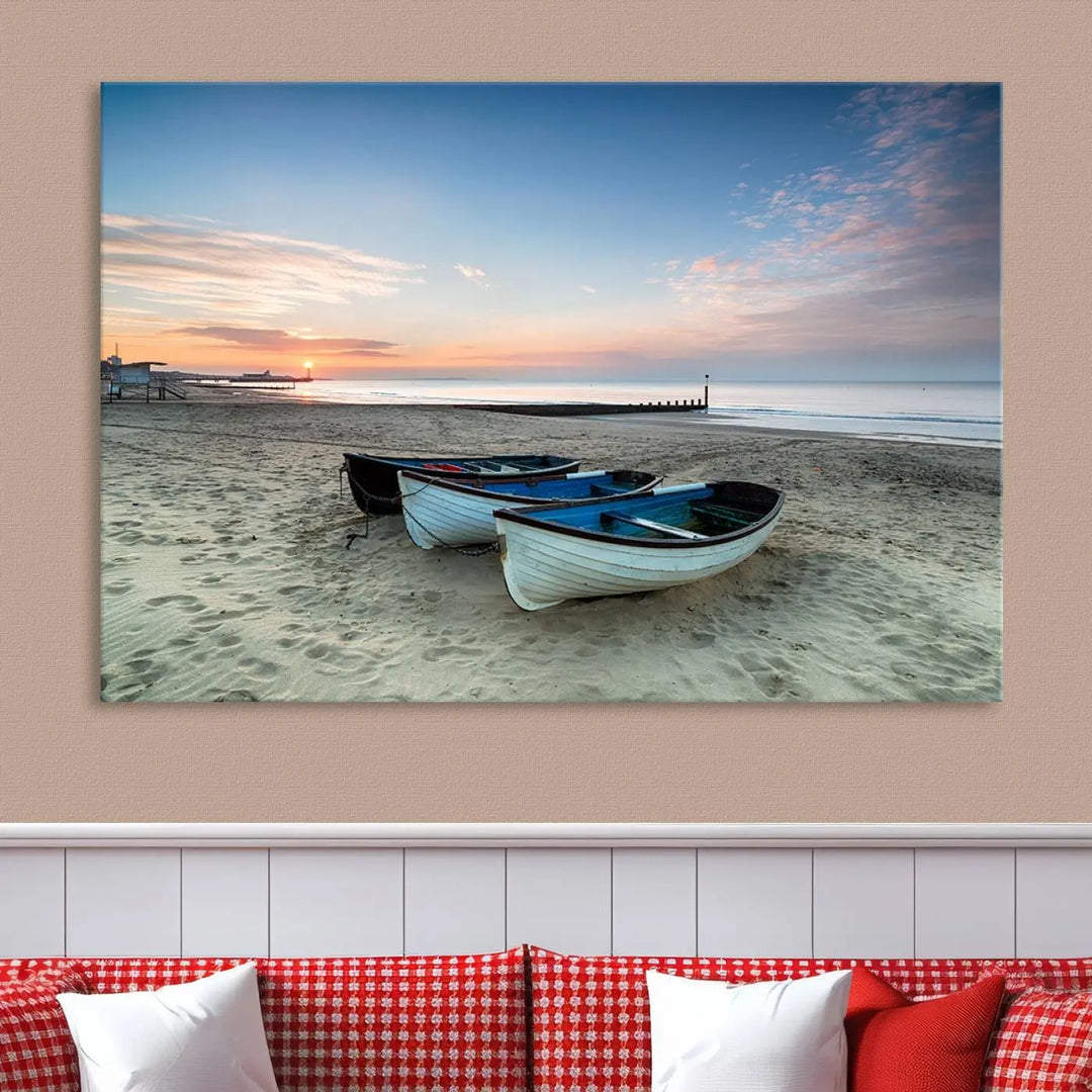 The "Boats On The Beach Wall Art Canvas Print," featuring a triptych photo of boats at sunset, is printed on museum-quality canvas with a UV-protective coating.