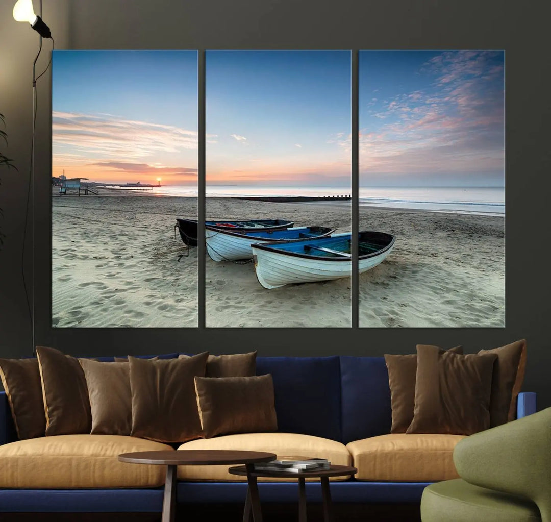 The "Boats On The Beach Wall Art Canvas Print," featuring a triptych photo of boats at sunset, is printed on museum-quality canvas with a UV-protective coating.