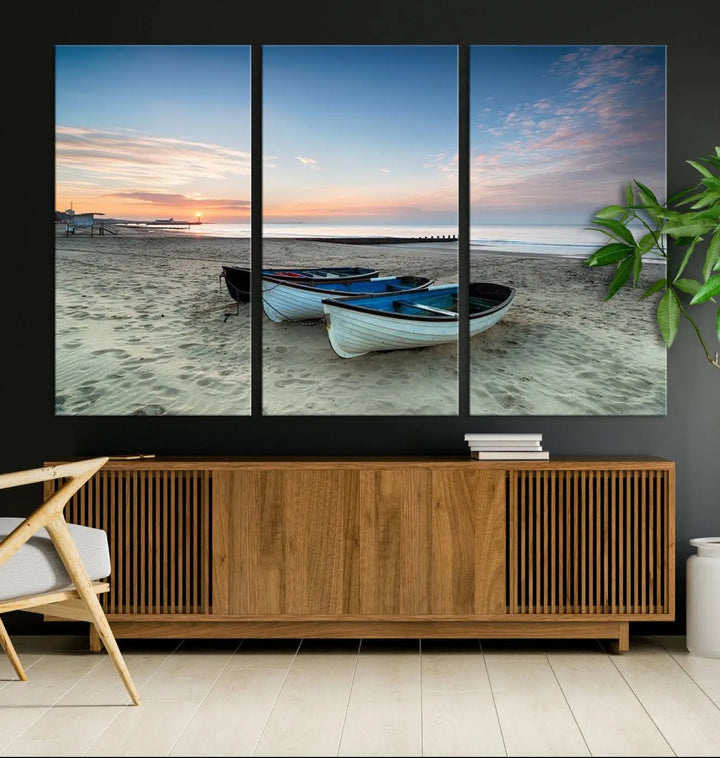 The "Boats On The Beach Wall Art Canvas Print," featuring a triptych photo of boats at sunset, is printed on museum-quality canvas with a UV-protective coating.