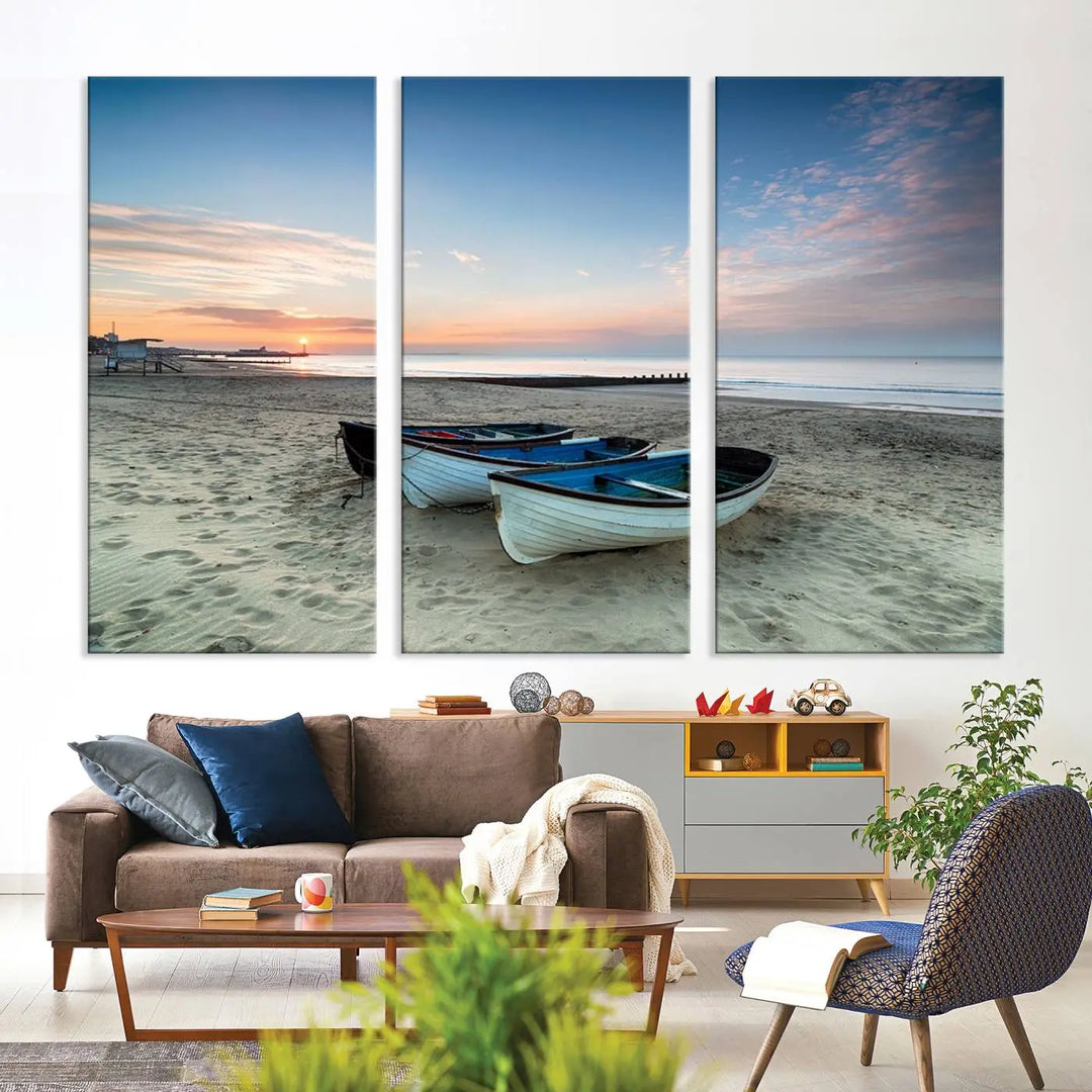 The "Boats On The Beach Wall Art Canvas Print," featuring a triptych photo of boats at sunset, is printed on museum-quality canvas with a UV-protective coating.