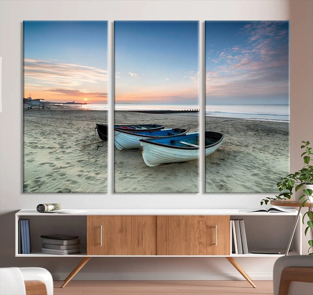 The "Boats On The Beach Wall Art Canvas Print," featuring a triptych photo of boats at sunset, is printed on museum-quality canvas with a UV-protective coating.