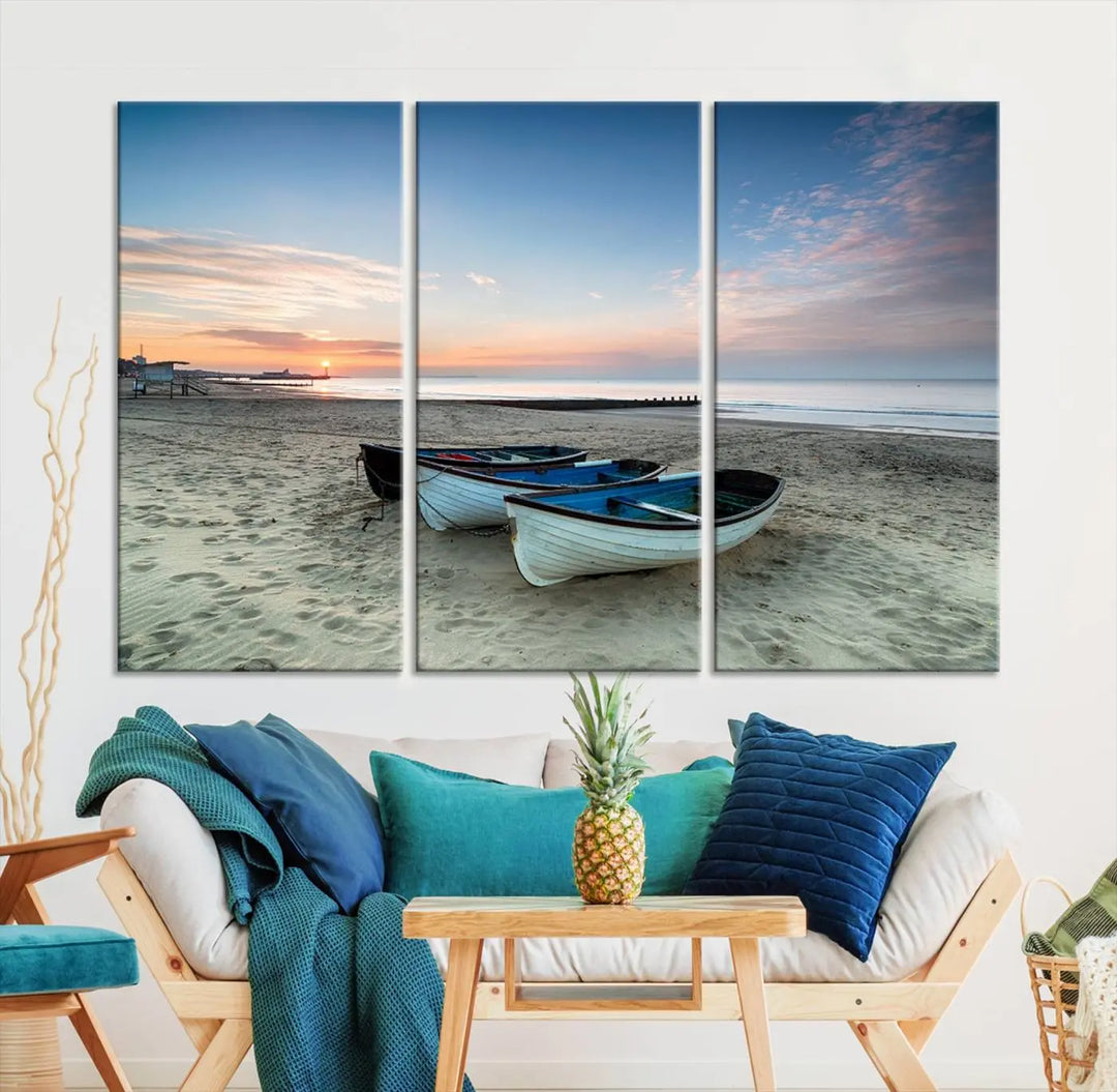 The "Boats On The Beach Wall Art Canvas Print," featuring a triptych photo of boats at sunset, is printed on museum-quality canvas with a UV-protective coating.