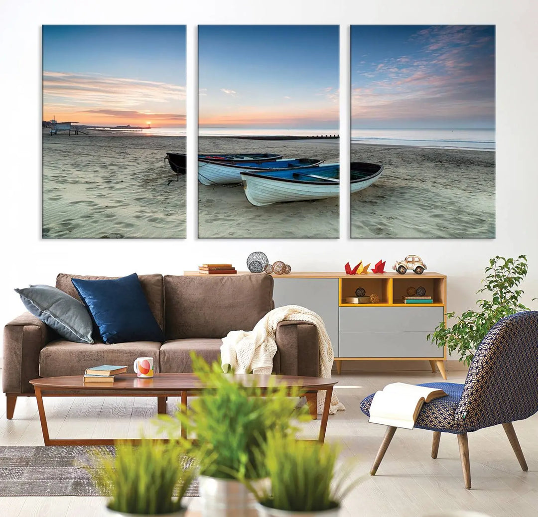 The "Boats On The Beach Wall Art Canvas Print," featuring a triptych photo of boats at sunset, is printed on museum-quality canvas with a UV-protective coating.