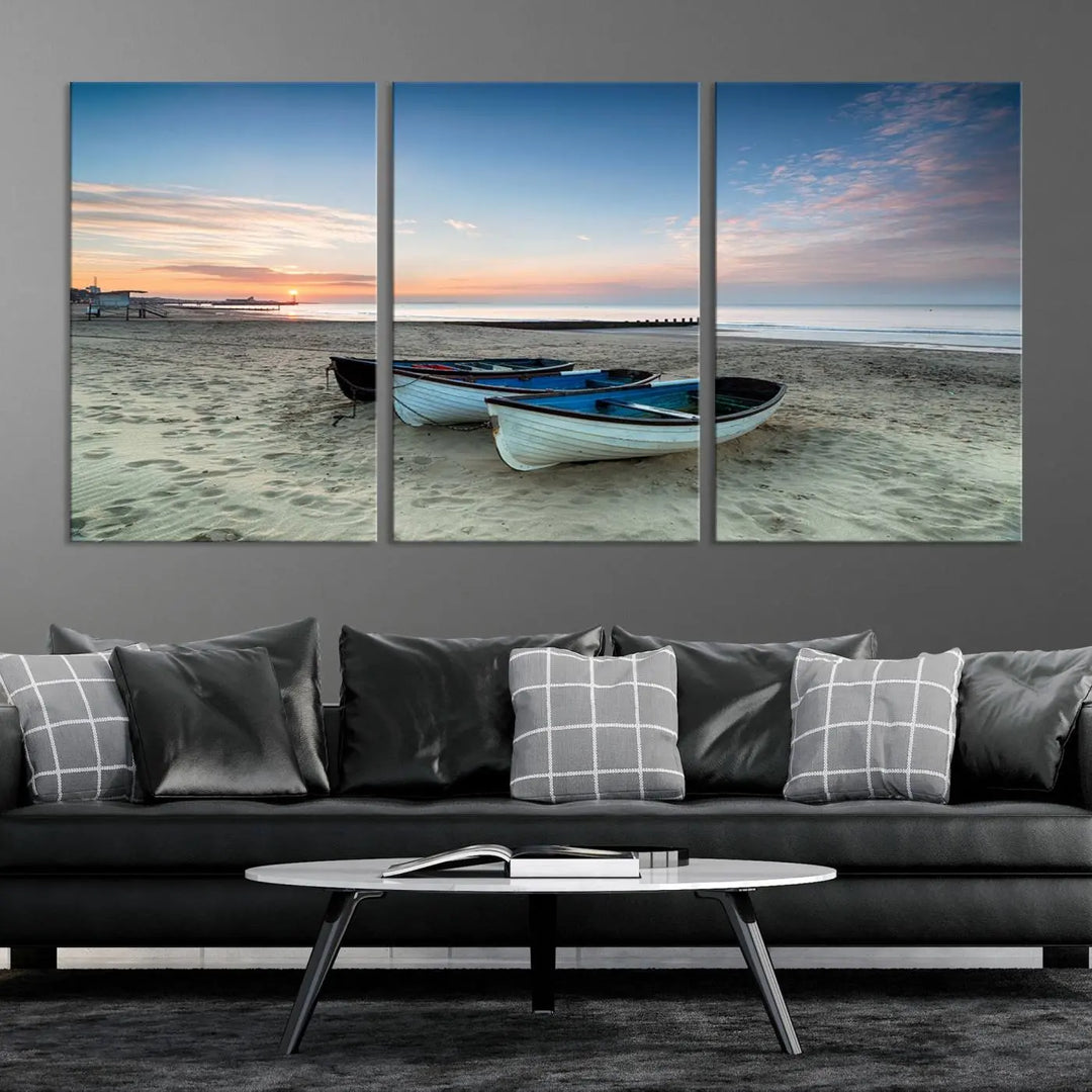 The "Boats On The Beach Wall Art Canvas Print," featuring a triptych photo of boats at sunset, is printed on museum-quality canvas with a UV-protective coating.