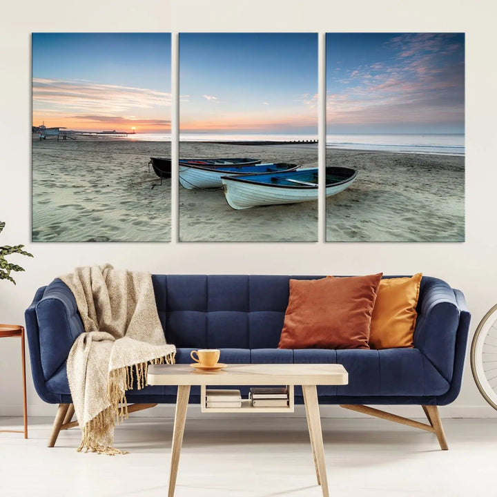 The "Boats On The Beach Wall Art Canvas Print," featuring a triptych photo of boats at sunset, is printed on museum-quality canvas with a UV-protective coating.