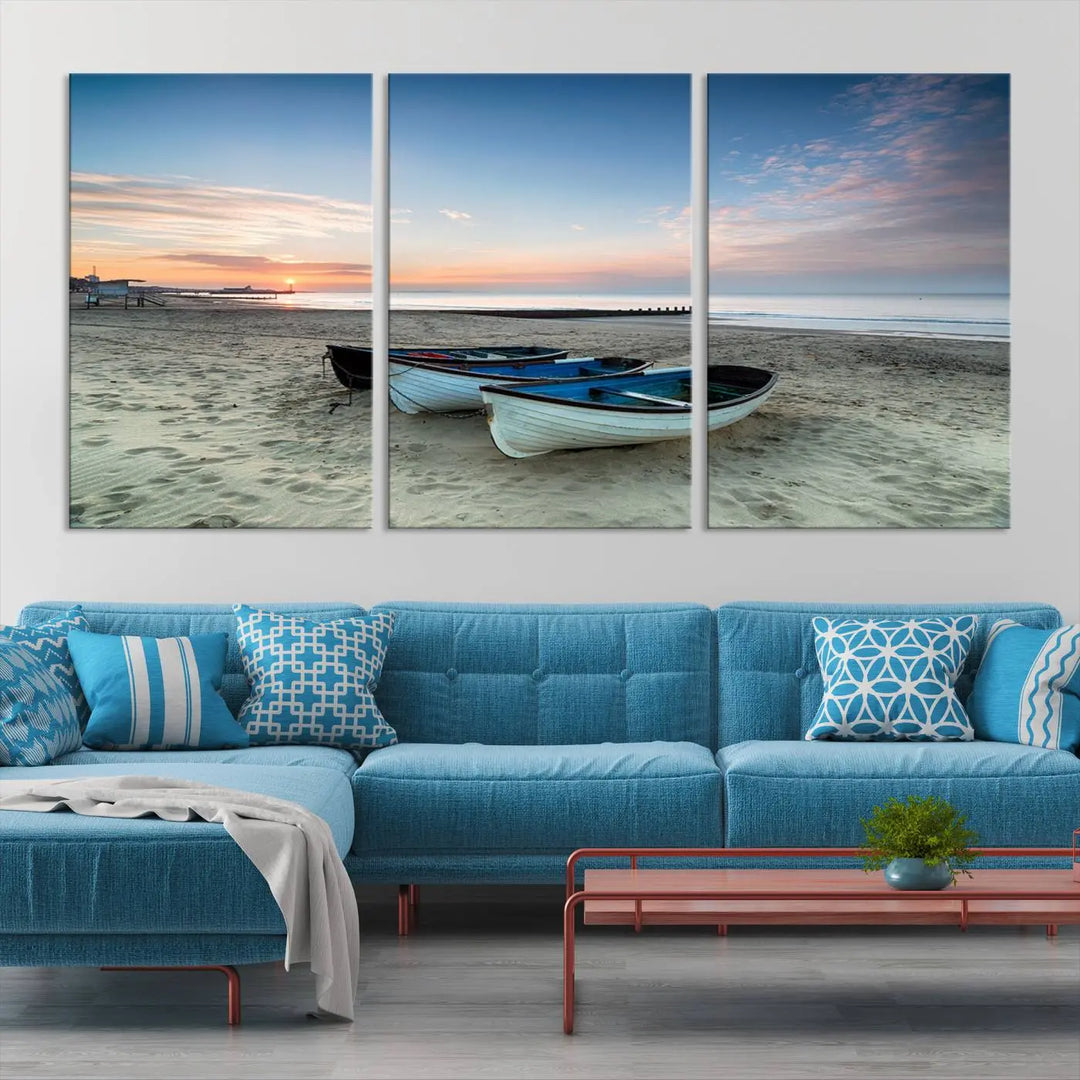 The "Boats On The Beach Wall Art Canvas Print," featuring a triptych photo of boats at sunset, is printed on museum-quality canvas with a UV-protective coating.