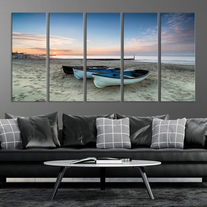 The "Boats On The Beach Wall Art Canvas Print," featuring a triptych photo of boats at sunset, is printed on museum-quality canvas with a UV-protective coating.