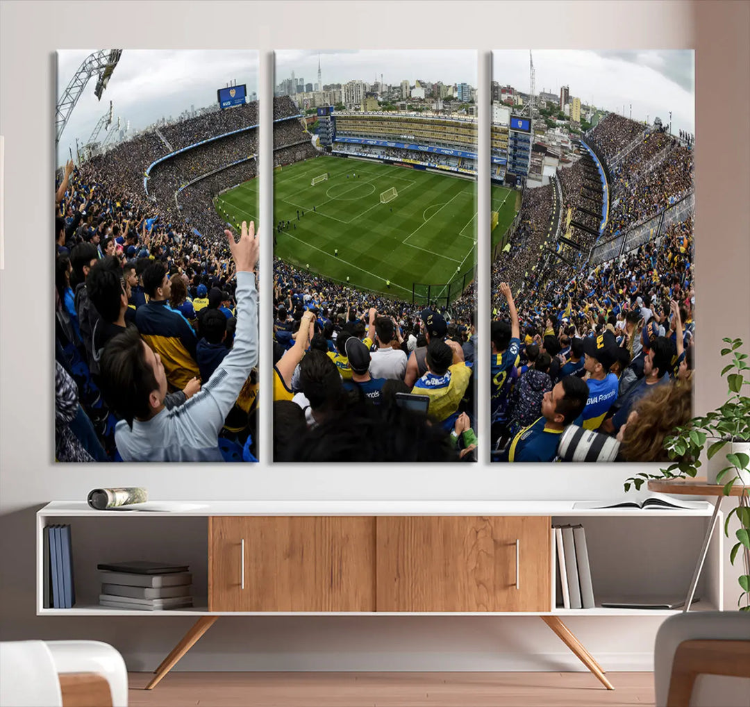 A triptych of the Buenos Aires Bombonera Stadium features the Boca Juniors Soccer Team, capturing cheering fans, a lush green field, and an urban skyline in the background. This scene is presented as museum-quality canvas art.