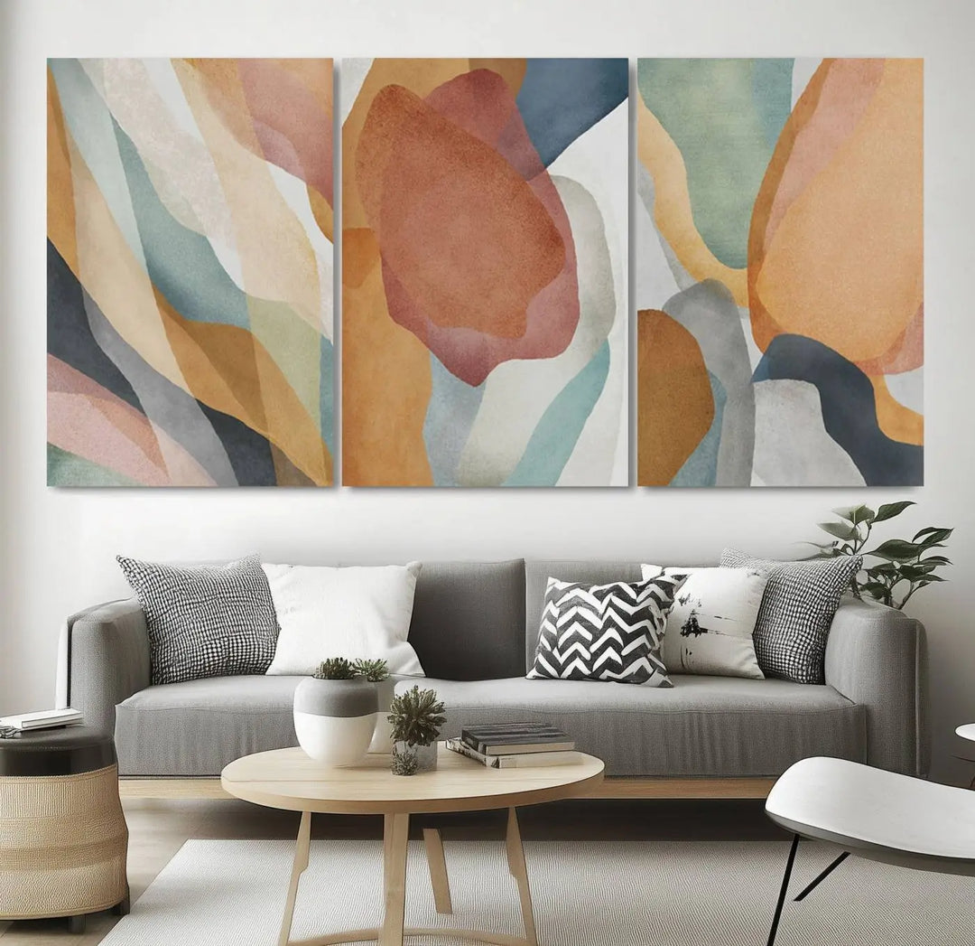 The Boho Wall Art Canvas Print Set, featuring warm hues in an abstract triptych, is presented on museum-quality canvas.