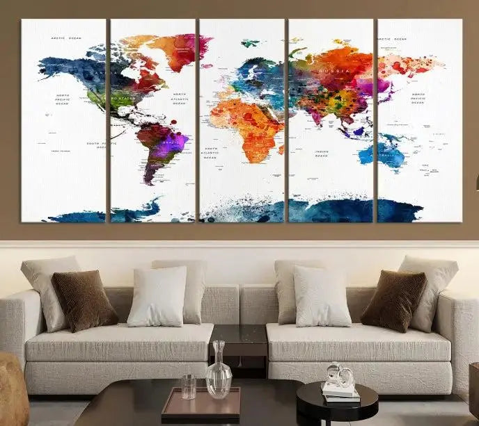 A bold and colorful world map from the "Bold & Colorful World Map Multi-Panel Framed Canvas Print" collection adorns three panels in a modern room. This ready-to-hang art piece infuses vibrant charm into any space.