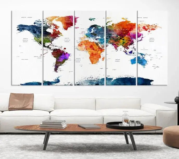 A bold and colorful world map from the "Bold & Colorful World Map Multi-Panel Framed Canvas Print" collection adorns three panels in a modern room. This ready-to-hang art piece infuses vibrant charm into any space.