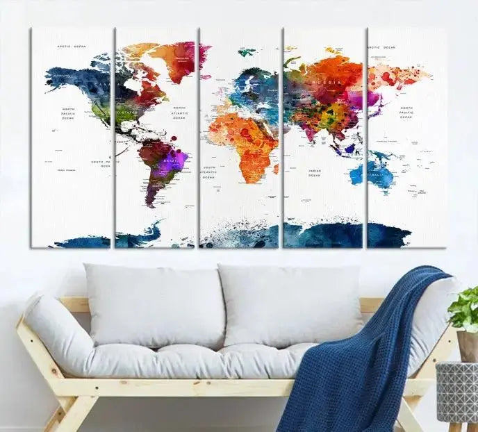 A bold and colorful world map from the "Bold & Colorful World Map Multi-Panel Framed Canvas Print" collection adorns three panels in a modern room. This ready-to-hang art piece infuses vibrant charm into any space.