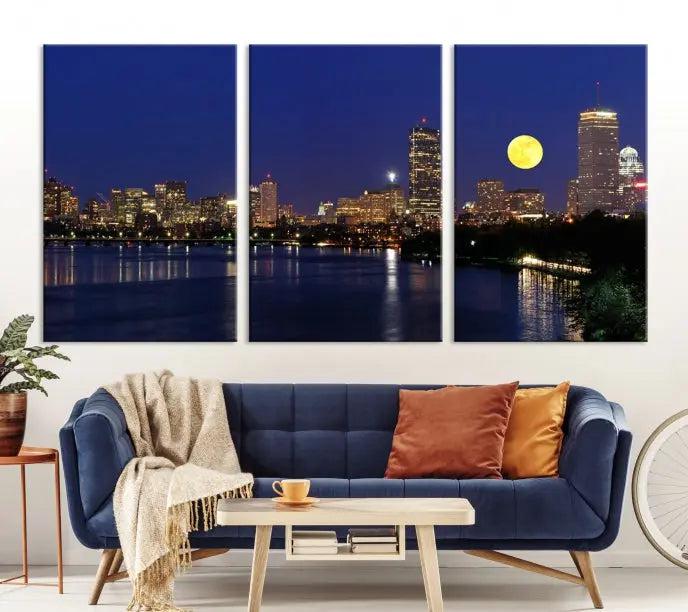 The "Boston City Lights Full Moon Night Skyline Cityscape View Wall Art Canvas Print" is a captivating triptych featuring a city skyline at night with a large moon. Crafted on museum-quality canvases, each piece is ready to hang and includes UV-protective coating to preserve its vibrant allure.