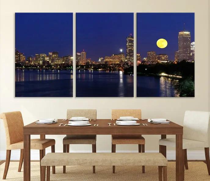 The "Boston City Lights Full Moon Night Skyline Cityscape View Wall Art Canvas Print" is a captivating triptych featuring a city skyline at night with a large moon. Crafted on museum-quality canvases, each piece is ready to hang and includes UV-protective coating to preserve its vibrant allure.