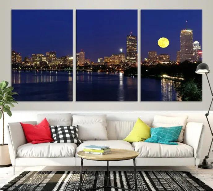 The "Boston City Lights Full Moon Night Skyline Cityscape View Wall Art Canvas Print" is a captivating triptych featuring a city skyline at night with a large moon. Crafted on museum-quality canvases, each piece is ready to hang and includes UV-protective coating to preserve its vibrant allure.