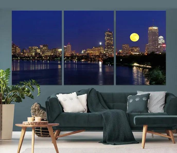 The "Boston City Lights Full Moon Night Skyline Cityscape View Wall Art Canvas Print" is a captivating triptych featuring a city skyline at night with a large moon. Crafted on museum-quality canvases, each piece is ready to hang and includes UV-protective coating to preserve its vibrant allure.