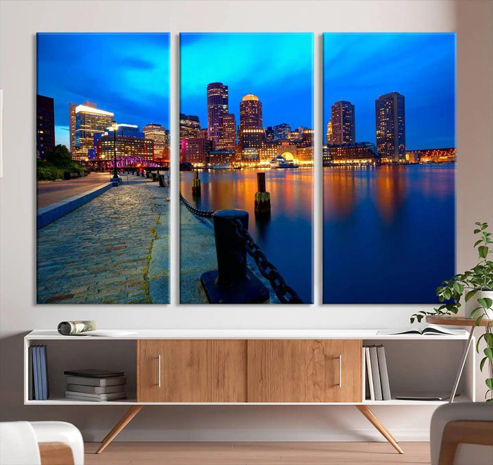 The "Boston City Lights Night Blue Skyline Cityscape" is a stunning large wall art of a city skyline at dusk, printed on museum-quality canvas with a UV-protective coating. It is ready to hang and can instantly transform your space.