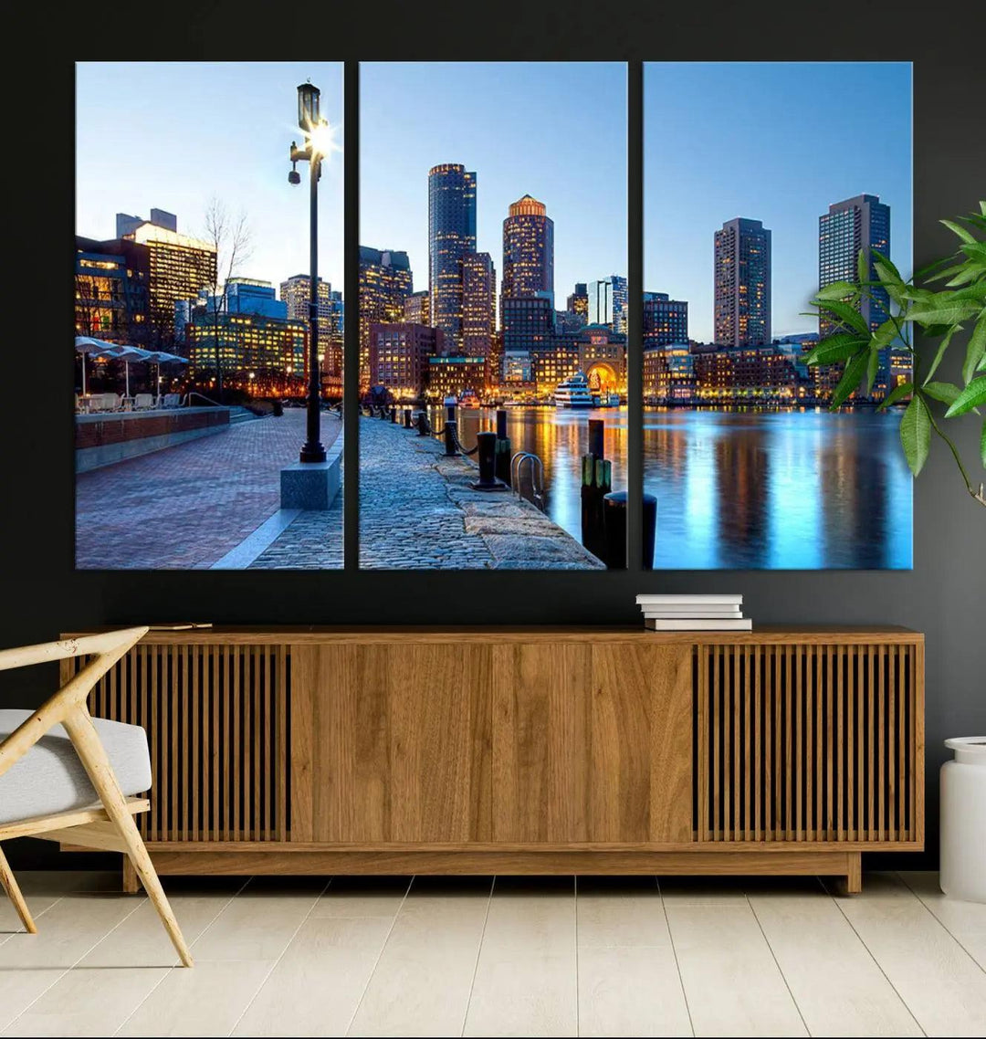 The modern living room features the Boston City Lights Sunrise Skyline Cityscape View Wall Art Canvas Print, crafted with museum-quality canvas and a UV-protective coating.