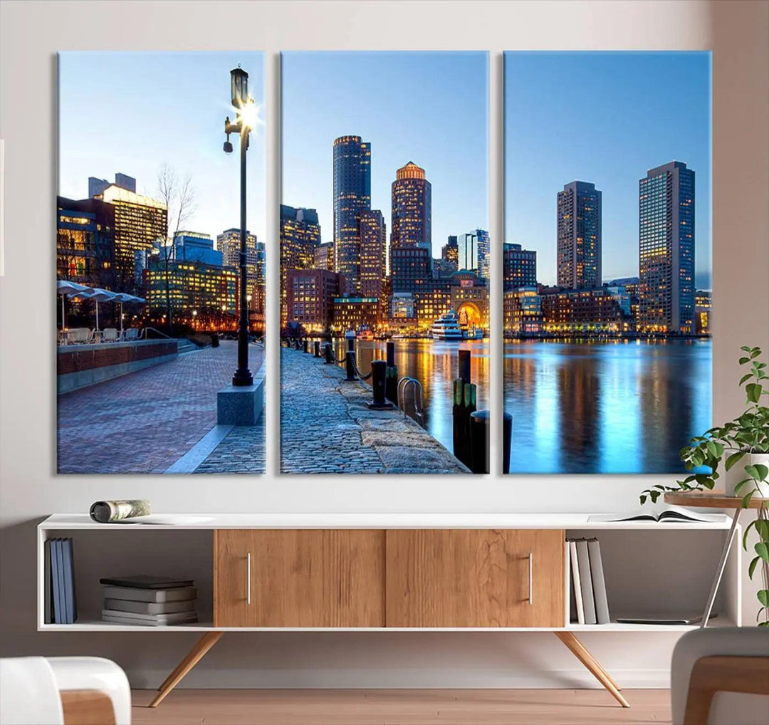 The modern living room features the Boston City Lights Sunrise Skyline Cityscape View Wall Art Canvas Print, crafted with museum-quality canvas and a UV-protective coating.