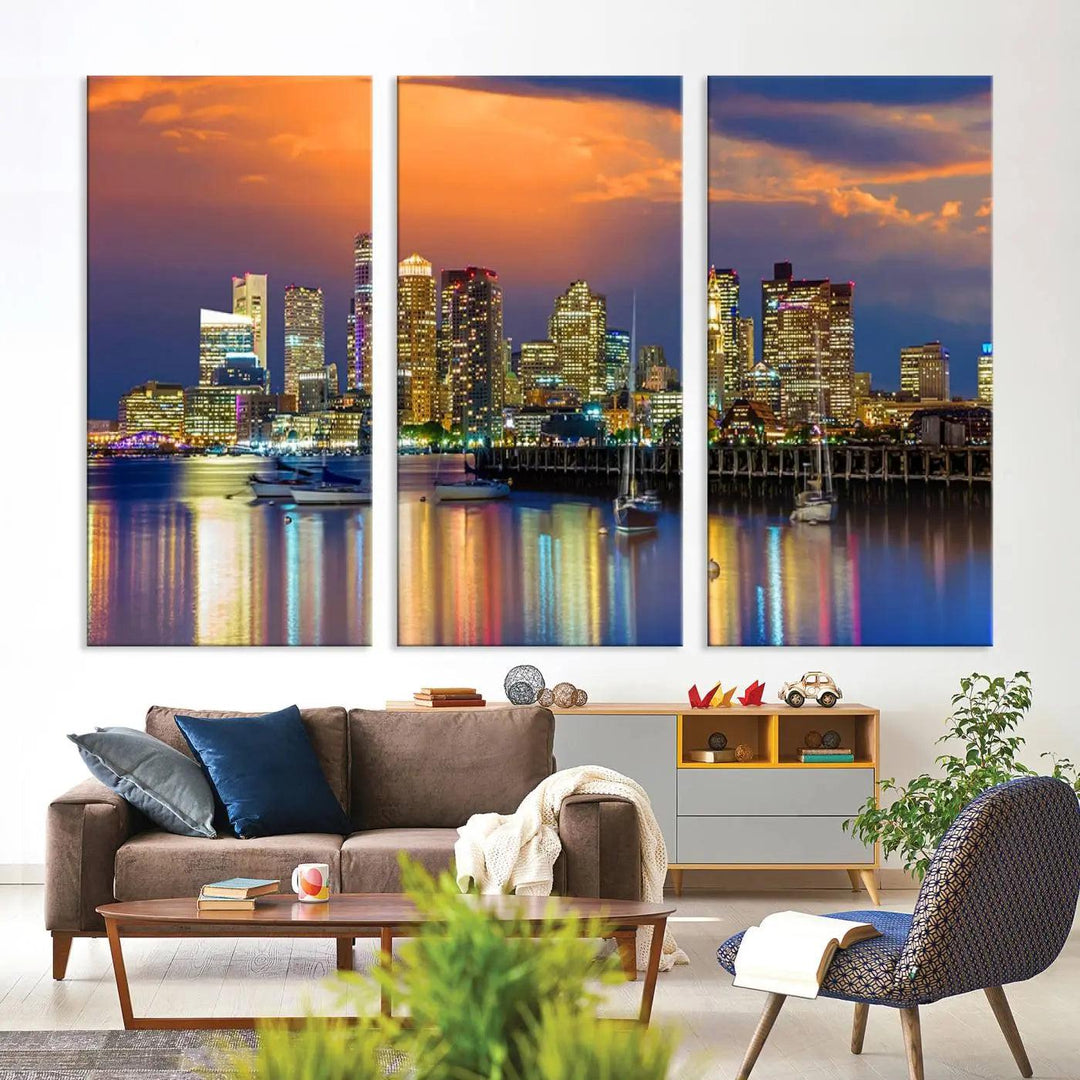 A contemporary dining area features a large triptych wall art of the Boston City Night skyline in blue and orange hues, printed on museum-quality canvases to ensure lasting beauty.