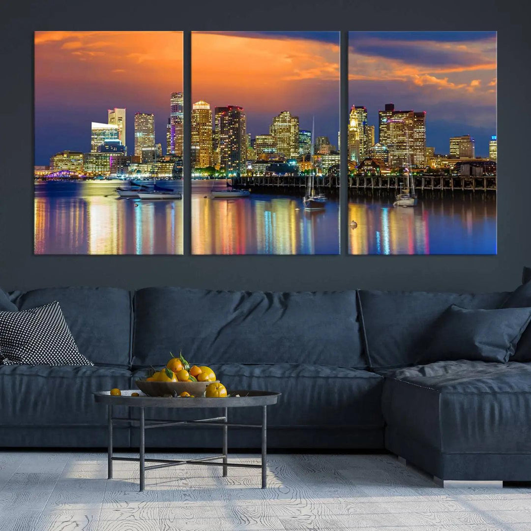 A contemporary dining area features a large triptych wall art of the Boston City Night skyline in blue and orange hues, printed on museum-quality canvases to ensure lasting beauty.