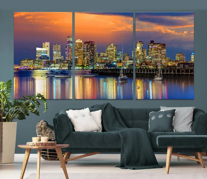 A contemporary dining area features a large triptych wall art of the Boston City Night skyline in blue and orange hues, printed on museum-quality canvases to ensure lasting beauty.