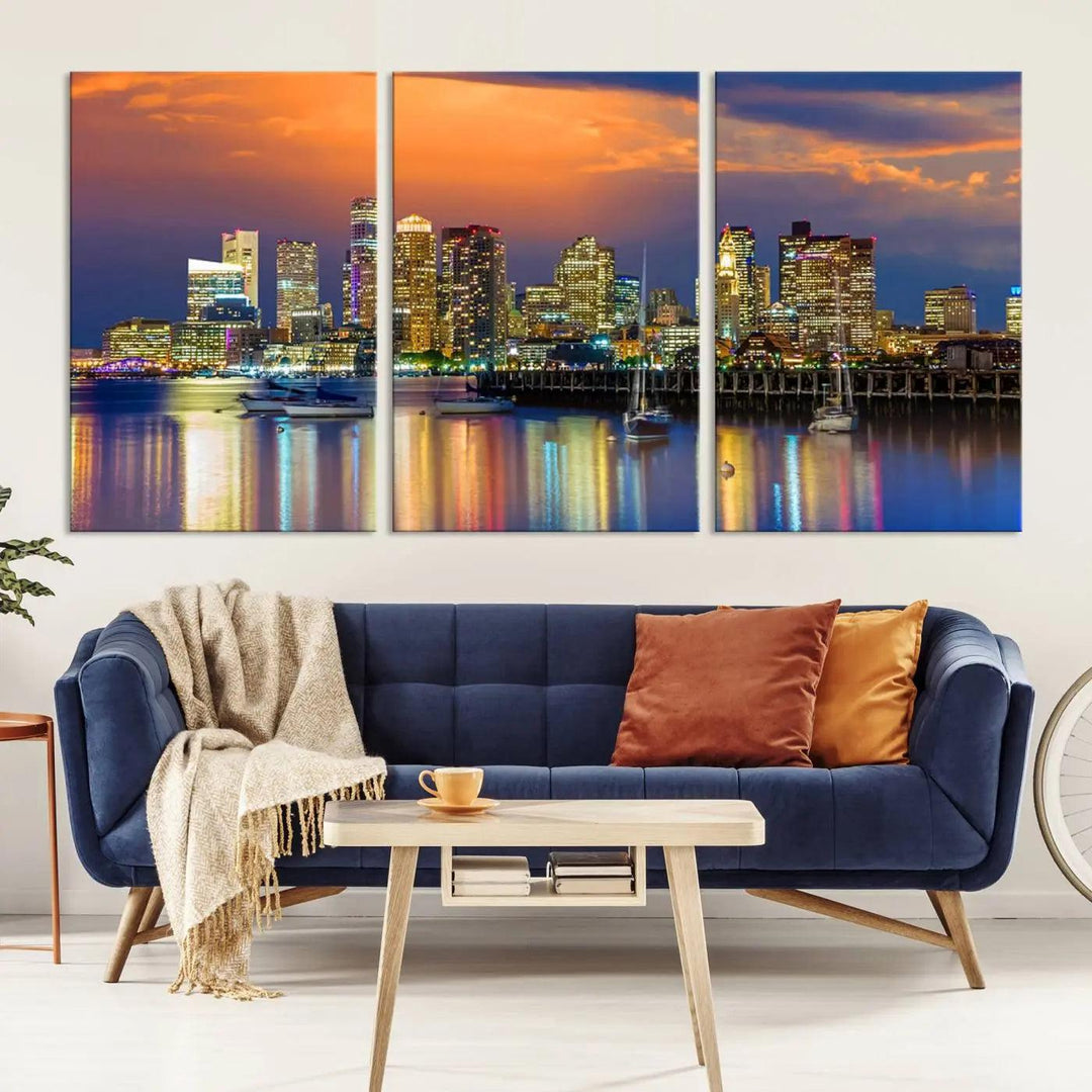 A contemporary dining area features a large triptych wall art of the Boston City Night skyline in blue and orange hues, printed on museum-quality canvases to ensure lasting beauty.