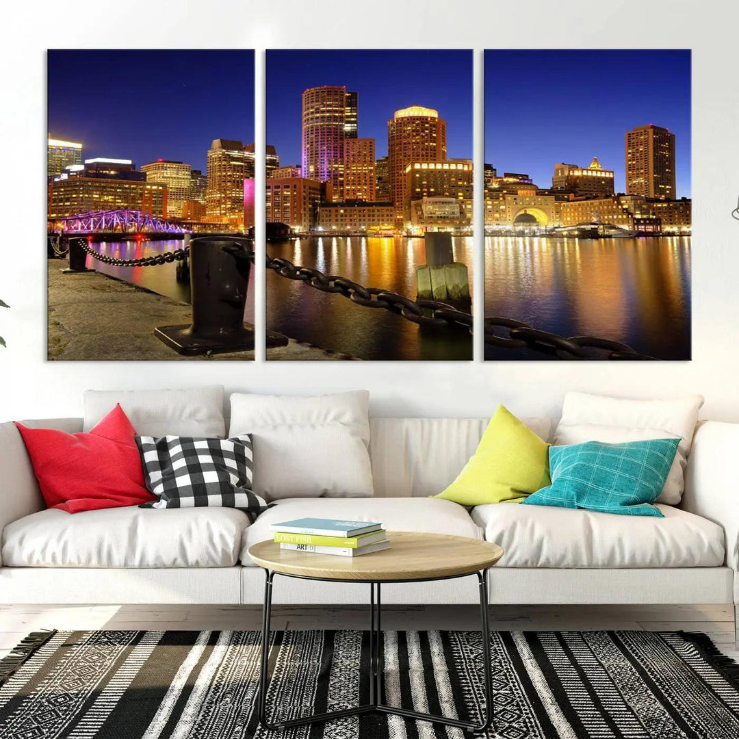 The "Boston City Night Skyline Cityscape View Wall Art Canvas Print" beautifully portrays a stunning triptych of a city skyline illuminated against the night sky, elegantly reflected in the river below. These museum-quality canvases are gallery wrapped to ensure an elegant presentation that enhances any space.