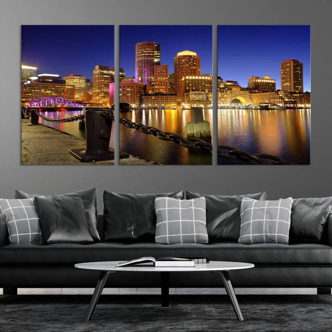 The "Boston City Night Skyline Cityscape View Wall Art Canvas Print" beautifully portrays a stunning triptych of a city skyline illuminated against the night sky, elegantly reflected in the river below. These museum-quality canvases are gallery wrapped to ensure an elegant presentation that enhances any space.