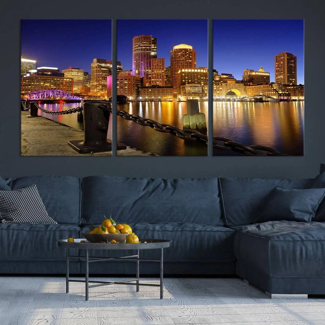 The "Boston City Night Skyline Cityscape View Wall Art Canvas Print" beautifully portrays a stunning triptych of a city skyline illuminated against the night sky, elegantly reflected in the river below. These museum-quality canvases are gallery wrapped to ensure an elegant presentation that enhances any space.