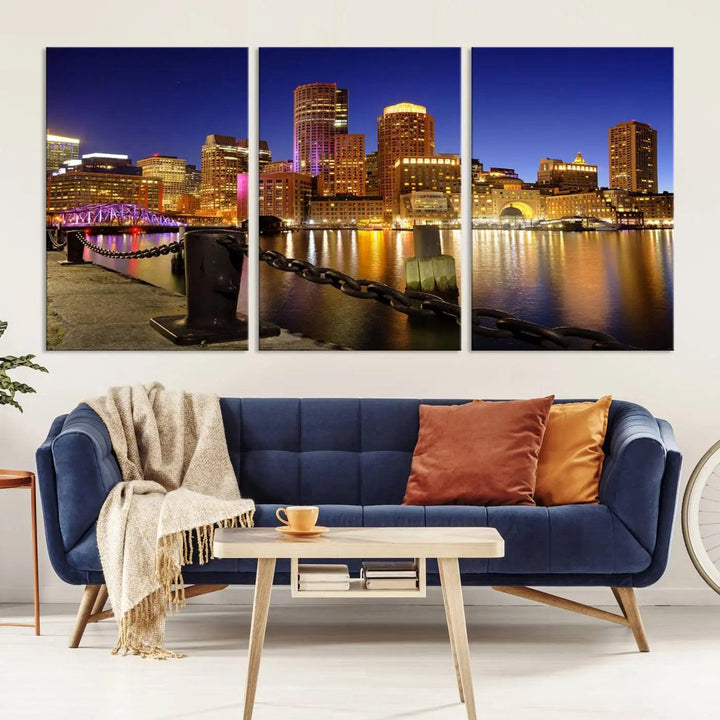 The "Boston City Night Skyline Cityscape View Wall Art Canvas Print" beautifully portrays a stunning triptych of a city skyline illuminated against the night sky, elegantly reflected in the river below. These museum-quality canvases are gallery wrapped to ensure an elegant presentation that enhances any space.