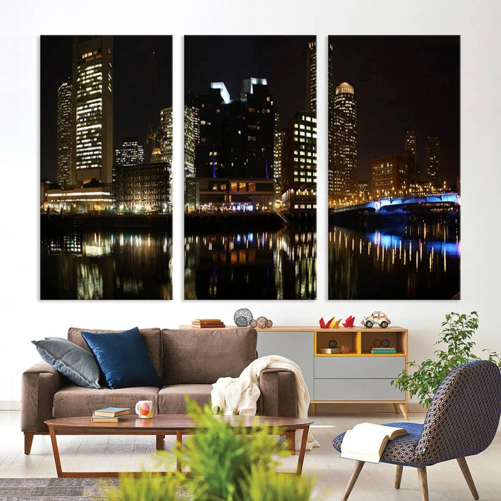 The Boston Night Skyline Cityscape View Wall Art Canvas Print depicts a triptych of the illuminated city reflected in water, enhancing a modern living room with its vibrant imagery. This gallery-wrapped masterpiece on museum-quality canvas brings an artistic flair to your space.