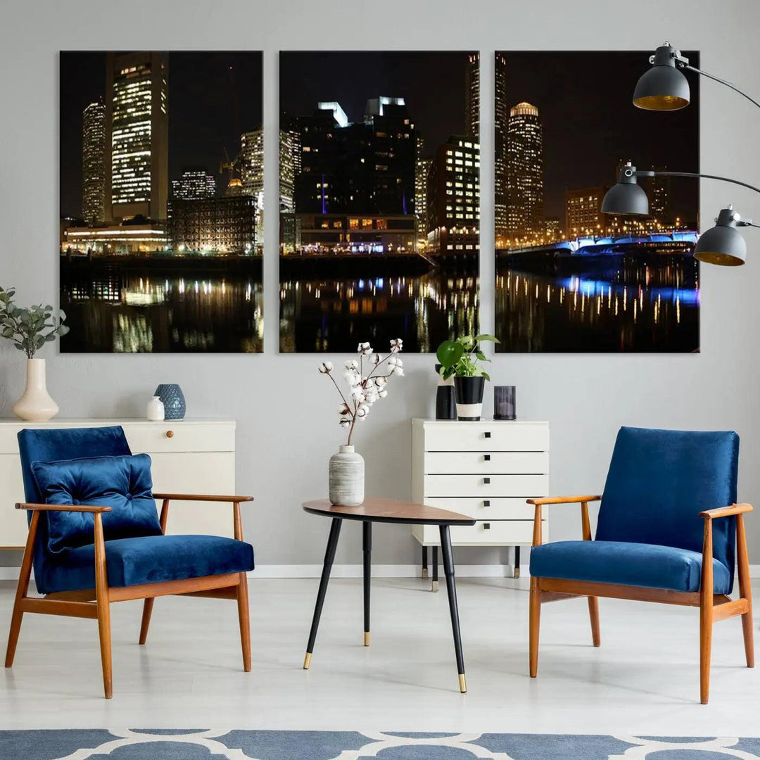 The Boston Night Skyline Cityscape View Wall Art Canvas Print depicts a triptych of the illuminated city reflected in water, enhancing a modern living room with its vibrant imagery. This gallery-wrapped masterpiece on museum-quality canvas brings an artistic flair to your space.