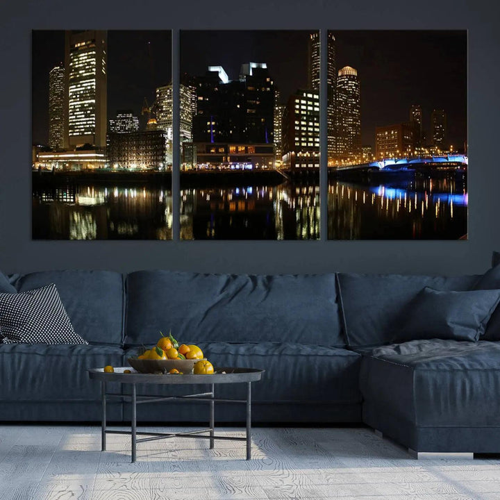 The Boston Night Skyline Cityscape View Wall Art Canvas Print depicts a triptych of the illuminated city reflected in water, enhancing a modern living room with its vibrant imagery. This gallery-wrapped masterpiece on museum-quality canvas brings an artistic flair to your space.