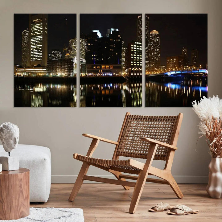 The Boston Night Skyline Cityscape View Wall Art Canvas Print depicts a triptych of the illuminated city reflected in water, enhancing a modern living room with its vibrant imagery. This gallery-wrapped masterpiece on museum-quality canvas brings an artistic flair to your space.